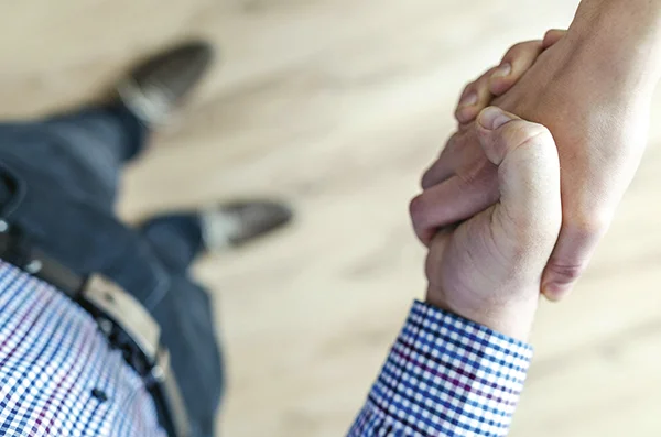 Kaksi henkilöä kättelee.